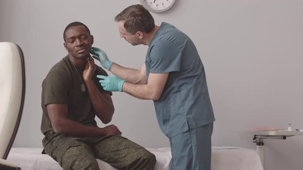 Doctor Examining African American Army Officer alt