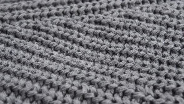 Knitted woolen gray surface of a warm sweater. Macro