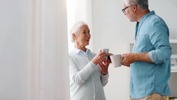 Happy Senior Couple Drinking Coffee at Home