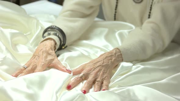 White Silk and Old Woman Manicured Hands.