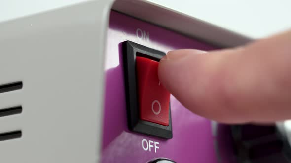 Pushing the red switch to the On position. Household power device with start button