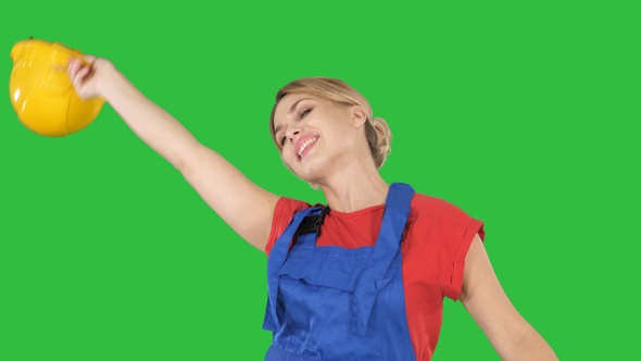 Tradeswoman dancing with a pencil on a Green Screen, Chroma Key.