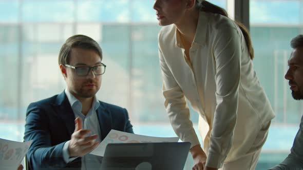 Working in office: mature business people at meeting. Corporate team discussing a project