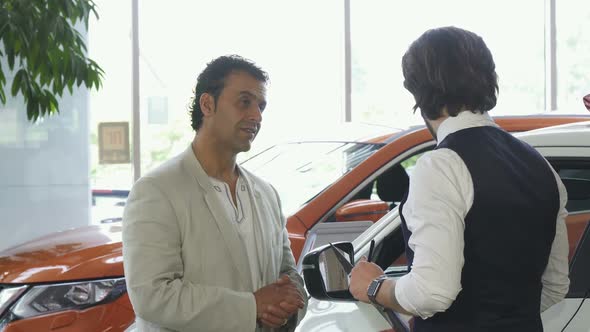 Mature Man Choosing a New Automobile at the Dealership