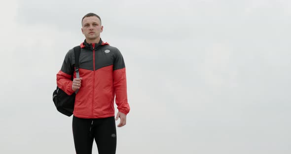 Young Man Walking in Training Sportswear Outdoors