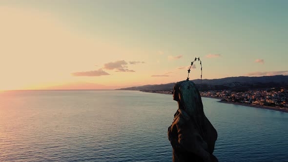 Statue of Madonna on the sunset