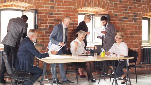 Group of Business People Brainstorming Together in Meeting Room