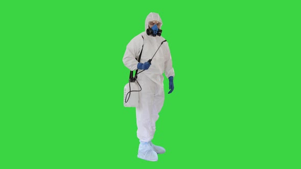 Disinfection For Virus Killing Worker in Hazmat Suit and Face Protection Mask Spraying Using