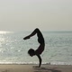 Woman practicing yoga on a beach - VideoHive Item for Sale