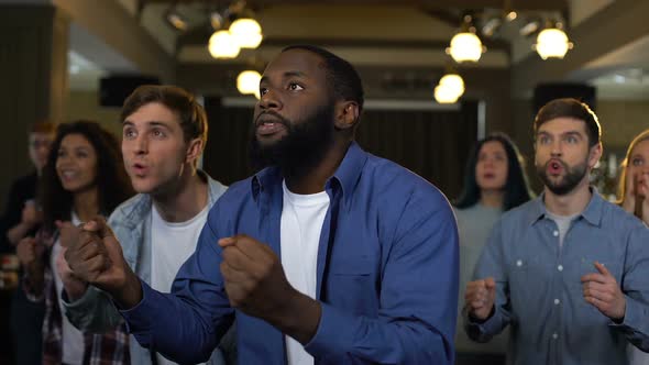 Emotional African Man With Friends Behind Rejoicing Victory, Project Success