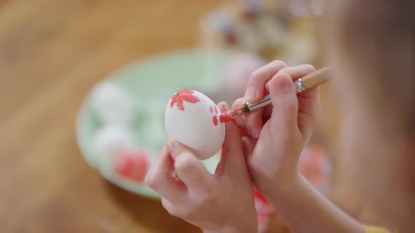 Hands of Child Painting on Easter Egg
