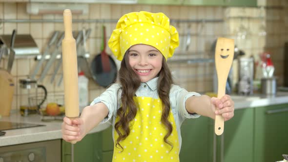 Smiling Girl with Kitchen Utensils.