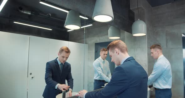 Two Business Man in Office Bathroom