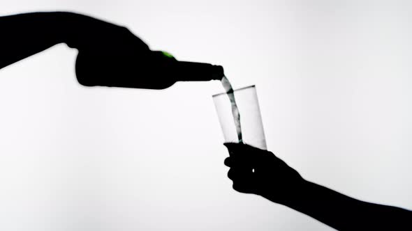 Pouring Beer Into Glass Isolated on White Background