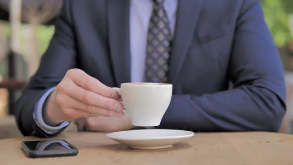 Close Up of Businessman Drinking Coffee