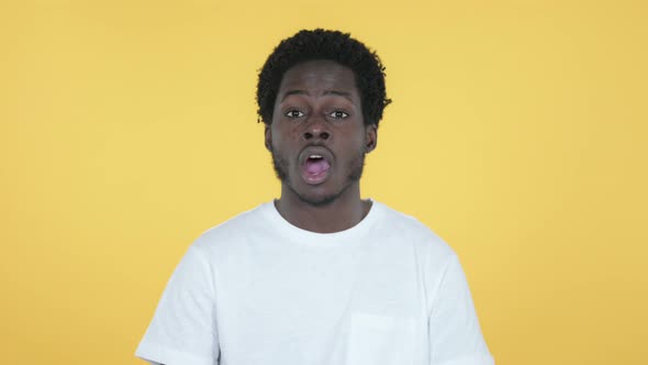 African Man Celebrating Success, Yellow Background