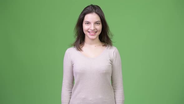 Young Happy Beautiful Woman Smiling Against Green Background