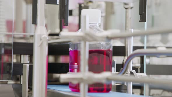 Automated pharmaceutical manufacturing line, bottles filled with liquid