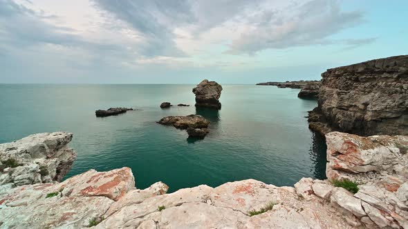 Rocky coastline with an alone rock in the sea