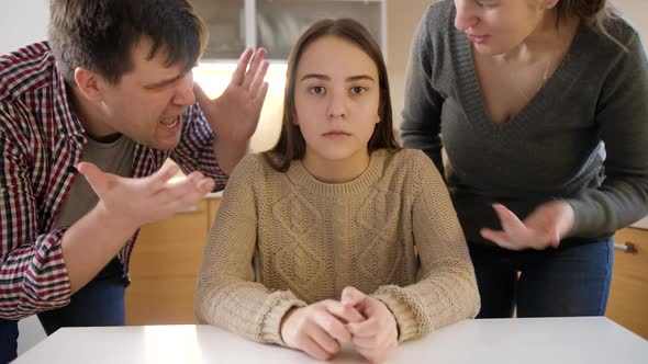 Teenage Girl Crying and Closing Face with Hands After Conflict with Parents