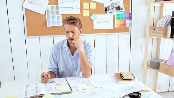 Young Successful Architector Thinking Considering Sitting at Workplace