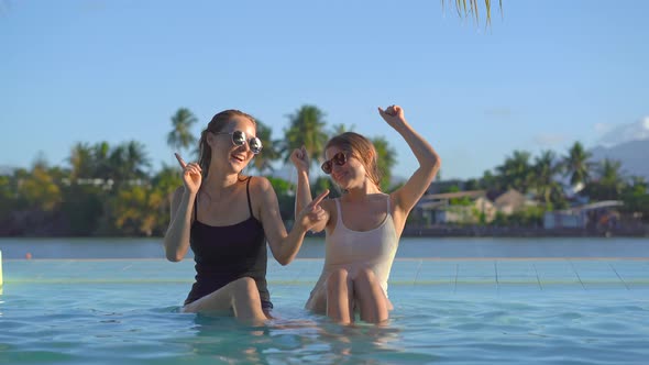 Young Women Have Fun in a Swimming Pool with Mineral Water in a Tropical Resort with Hot Springs