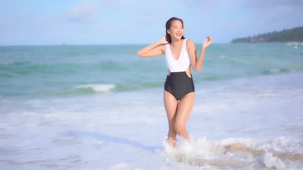 Asian woman enjoy around beautiful beach sea ocean