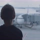 Curious Boy Looks Out of Panoramic Window at Large Airplane - VideoHive Item for Sale