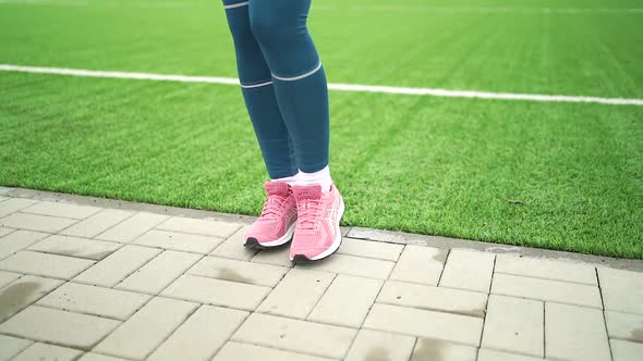 Portrait of woman in sportswear doing sports warm-up at the stadium Video HD Slow motion