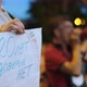 Male Protester Talking with Megaphone Bullhorn While Activist Holds Banner Sign - VideoHive Item for Sale