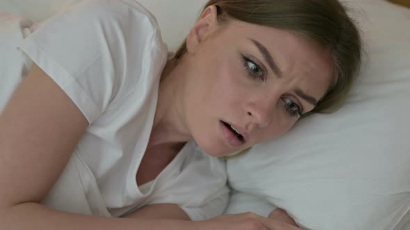 Portrait of Attractive Young Woman Having Nightmare in Bed 