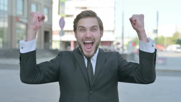 Portrait of Excited Businessman Celebrating Success Outdoor