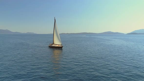 Aerial view circulating a sailboat in the mediterranean sea, Vathi, Greece.