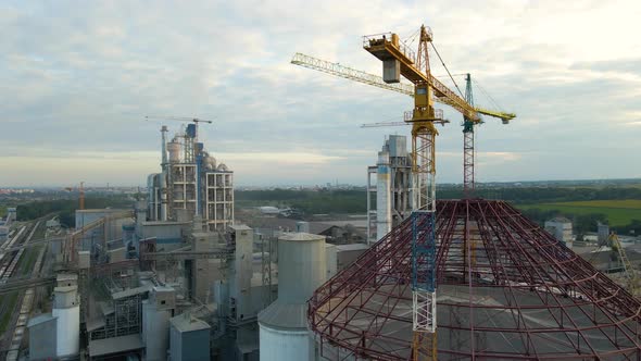 Aerial View of Cement Factory with High Concrete Plant Structure and Tower Crane at Industrial