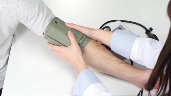 Sphygmomanometer Being Used of Woman Doctor