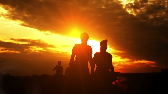 Couple Walking on Summer Evening Embankment. Beautiful Evening Sunset Sky.