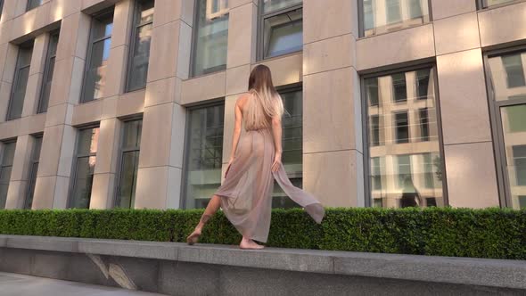 Beautiful Young Girl Dancing Performing Contemporary on the Street of a Modern City. Slow Motion.