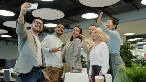 Diverse Group of People Coworkers Talking Selfie at Work with Smartphone Camera