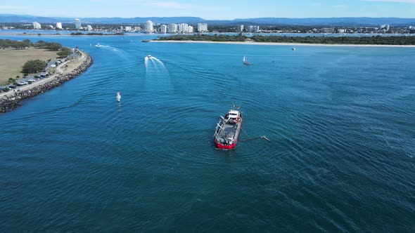 Industrial sand dredging ship excavating in a highly sensitive marine environment close to a popular