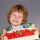 Blonde boy is happy about delicious strawberries from the farmers market. - VideoHive Item for Sale