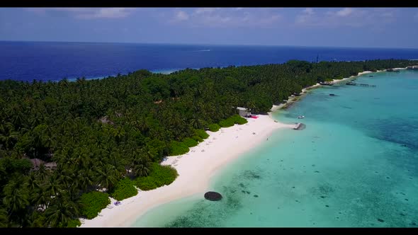 Aerial panorama of exotic tourist beach voyage by blue green lagoon and clean sandy background of ad