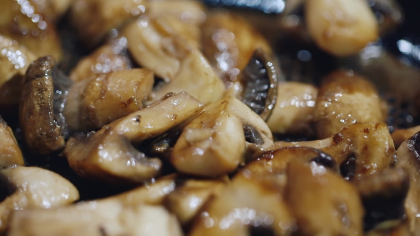 Almost Ready Fried Mushrooms in a Frying Pan. Beneath Them Is Boiling Oil