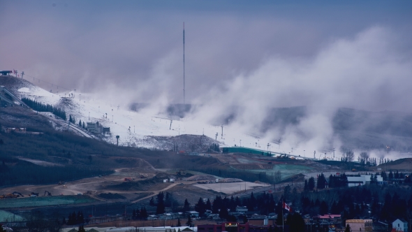 Artificial Snow Guns Blowing Snow on a Ski Hill Early Winter