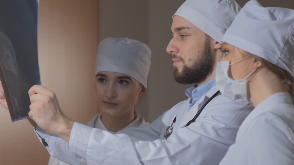 Healthcare, Medical: Group of Multi-ethnic Doctors Discussing and Looking X-ray in a Clinic alt