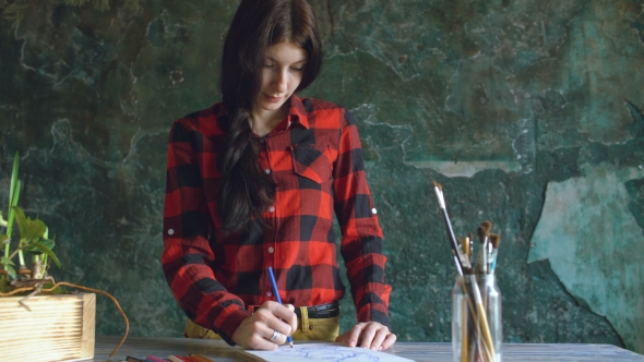 Young Woman Artist Painting Scetch on Paper Notebook with Pencil