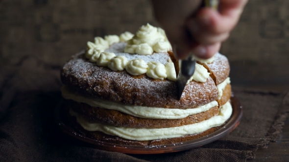 Chef Slicing Cake with Cream. Cutting Cake Dessert. Carrot Pie Slicing on Table