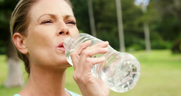 Female athlete drinking water