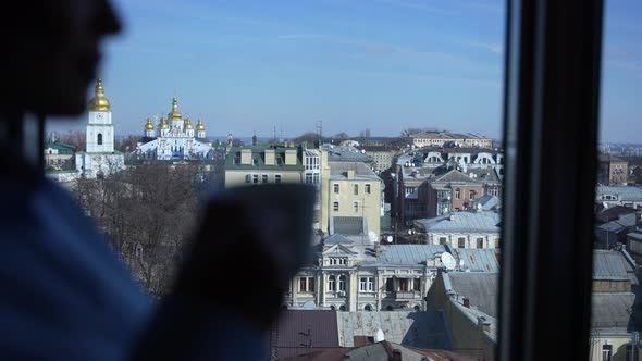 Scenic Cityscape Observed By Woman at Hotel Window