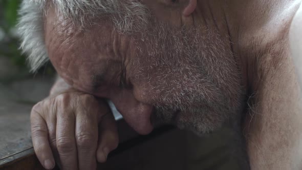 Old Depressed Man at the Table