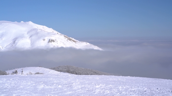 Snow-capped Mountains Above the Clouds